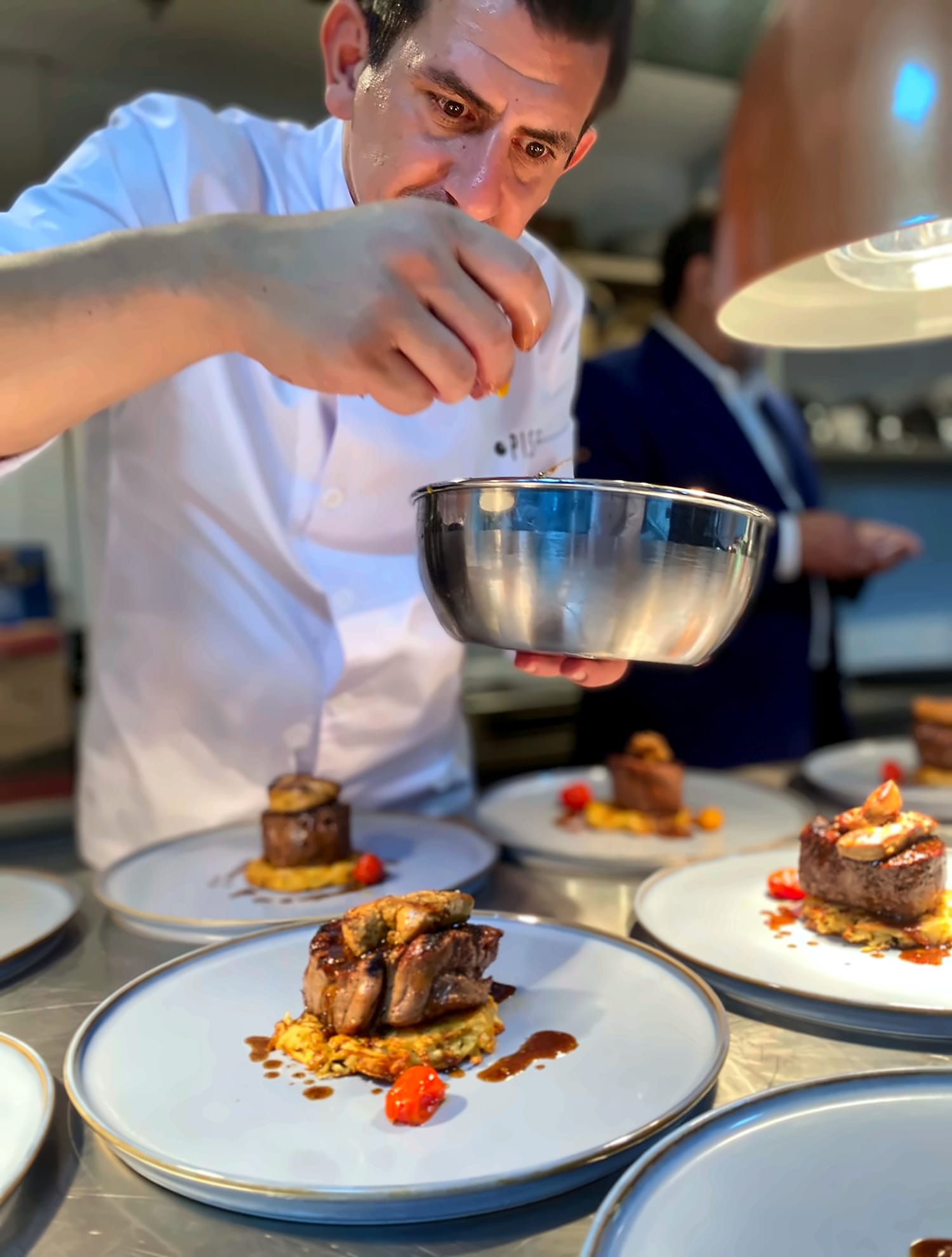 Chef Ufuk Ozan finishing the meat course